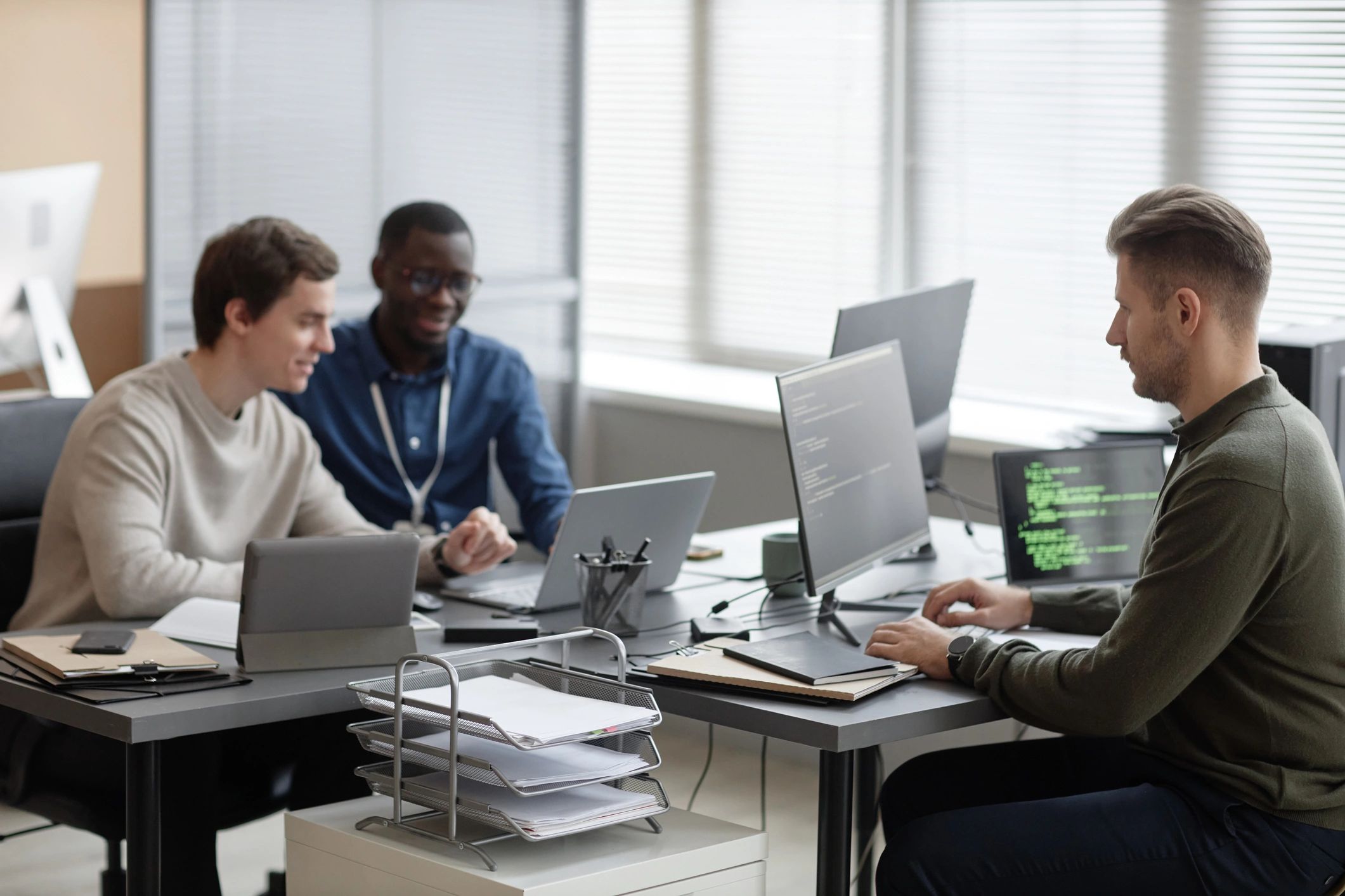 IT team working on cybersecurity and technical support in a modern office