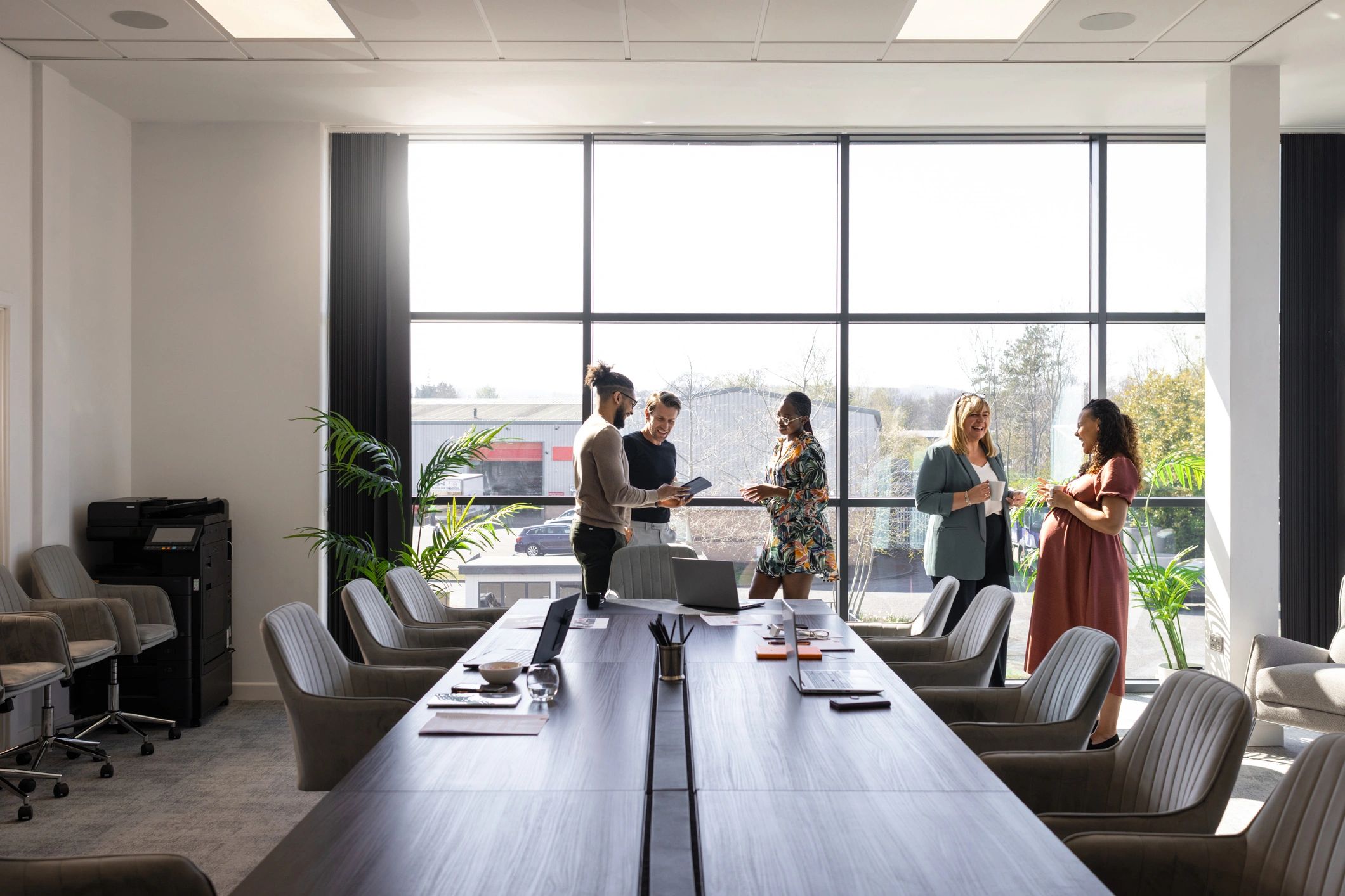 Colleagues discussing strategy in a modern office